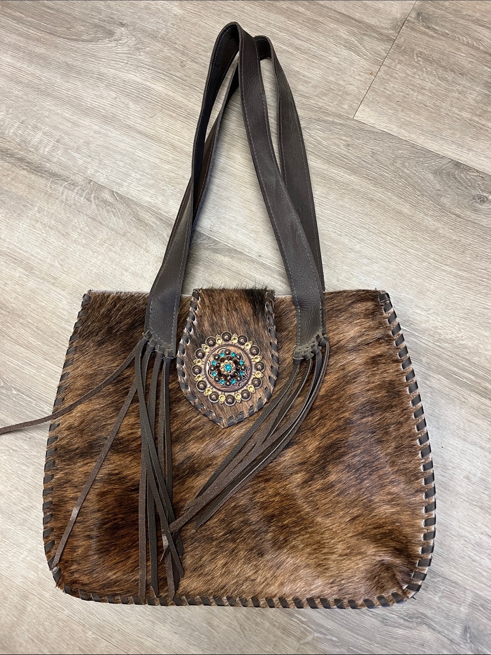 Brown Haircalf Fringe Tote Bag with Decorative Medallion